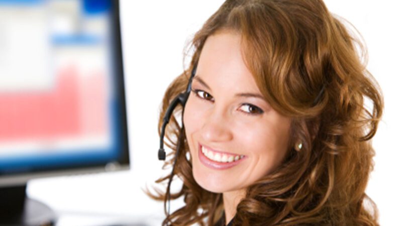a woman with phone headset smiling