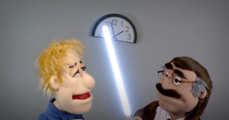 two puppets discovering a lightsaber