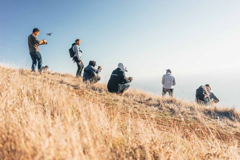 A group of photographers on a hillside