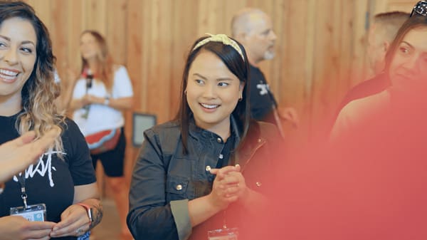 woman smiling and looking at speaker