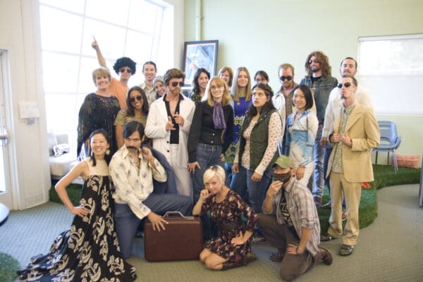 Duarte team poses for a picture in their 70's outfits