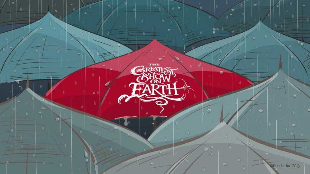 Red umbrella in the rain "Greatest Show on Earth" written on the top of it