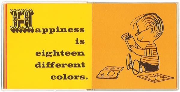 A page in the book "Happiness is eighteen different colors." on a yellow page next to an orange page