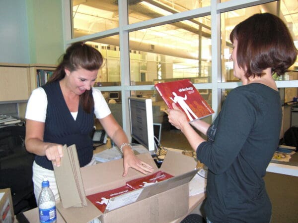 slide:ology is here! Nancy and Michaela opening the first set of printed books