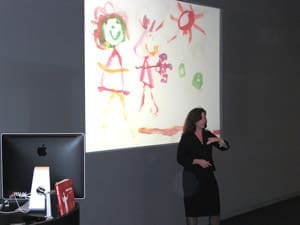 Nancy presenting a child's drawing at the Apple Store