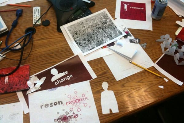 Brainstorming by cutting out silhouettes of people to create a new book cover for "Resonate"